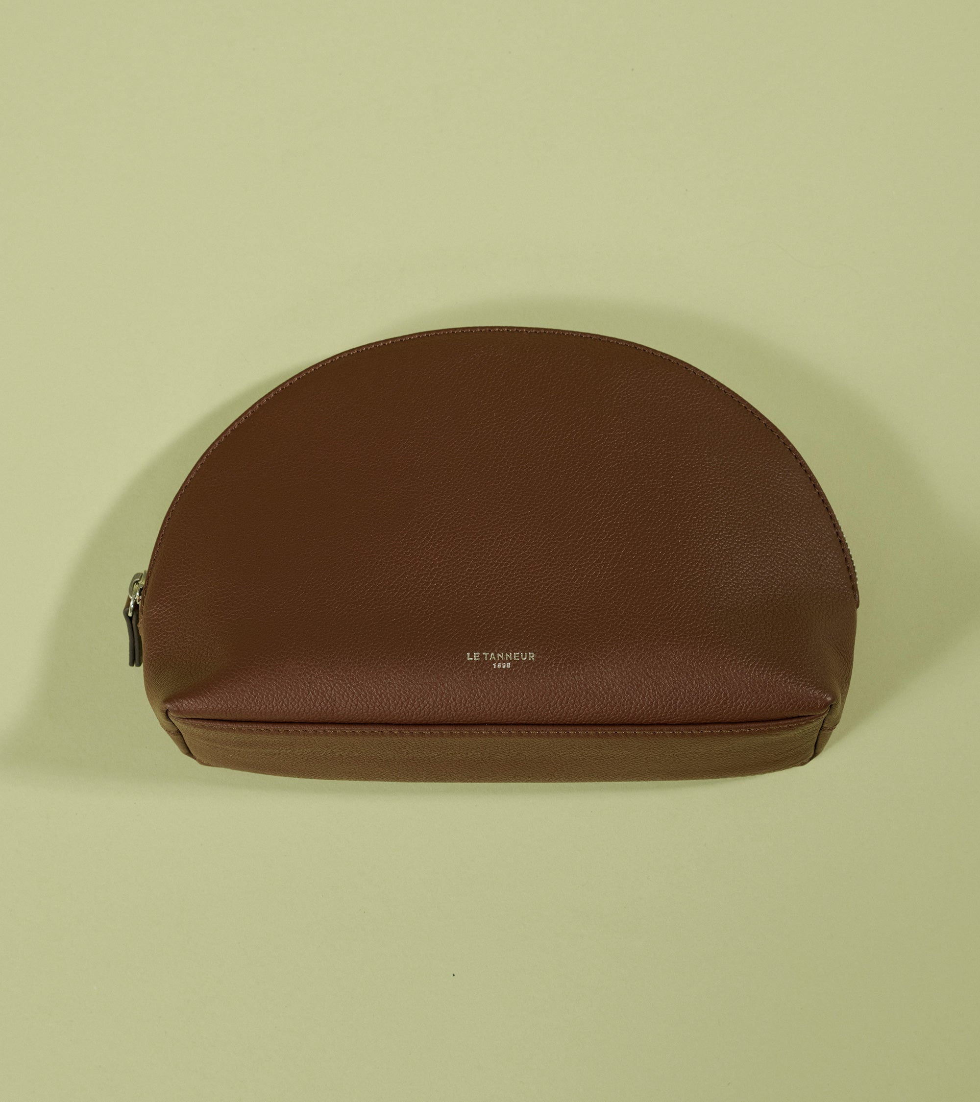 Half-moon toiletry bag in grained leather